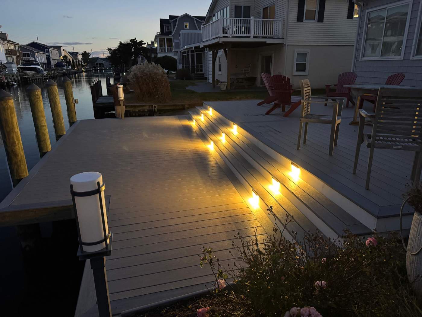 bethany-beach-deck-construction-delmarva-decking.jpg Custom deck built in South Bethany using pvc decking, on a canal with step lights, Delmarva Decking