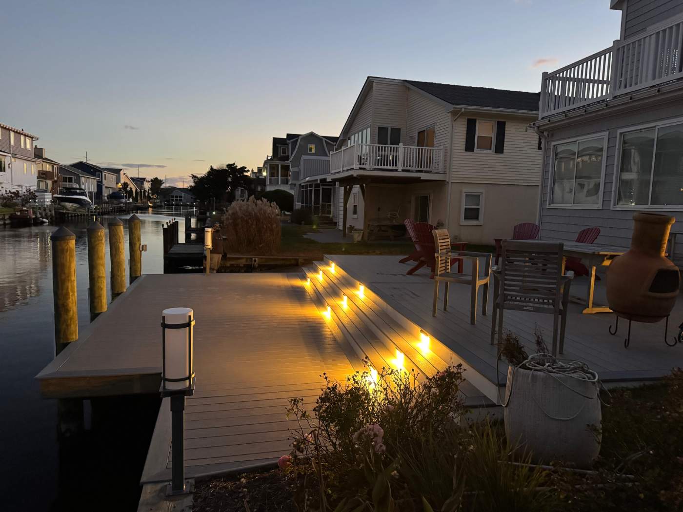 bethany-beach-deck-contractor-delmarva.jpg Custom deck built in South Bethany with Wolf Decking Boards, on a canal with step lights, Delmarva Decking
