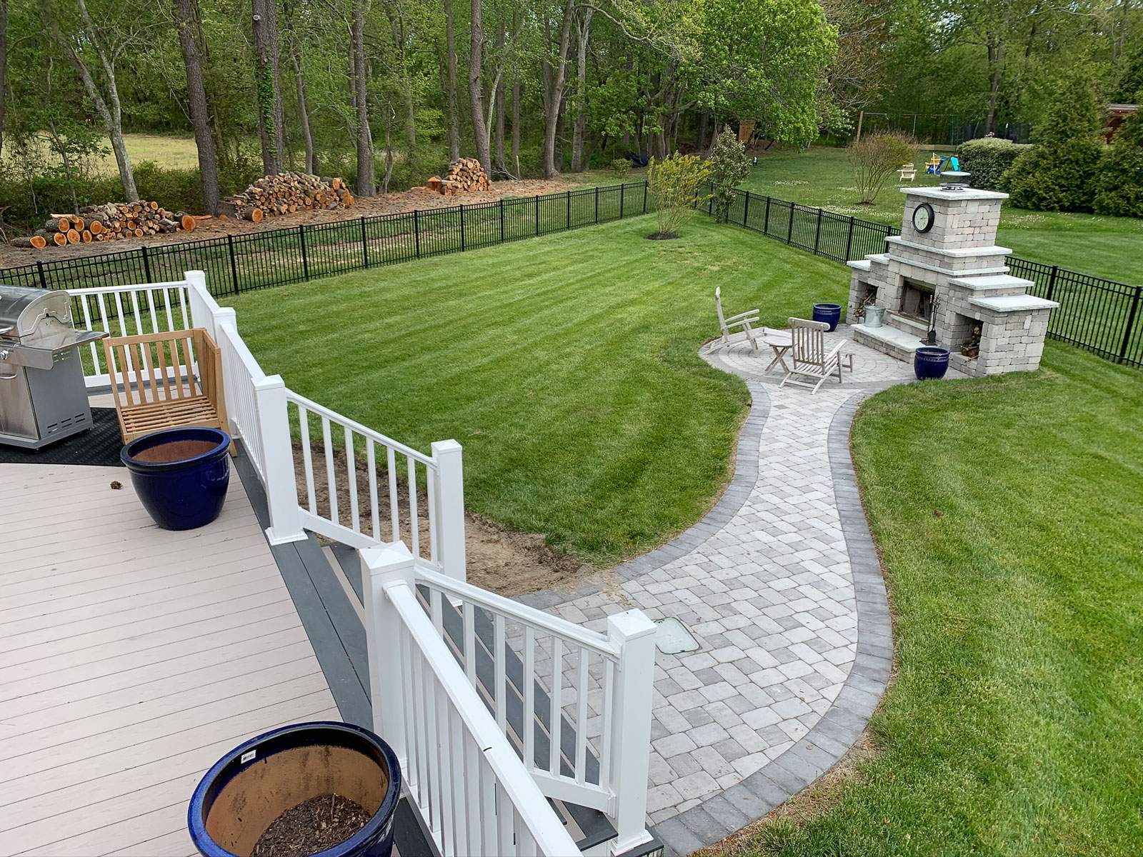 lewes-outdoor-living-builder-delmarva-decking.jpg Deck with a walkway to a outdoor fireplace by Delmarva Decking
